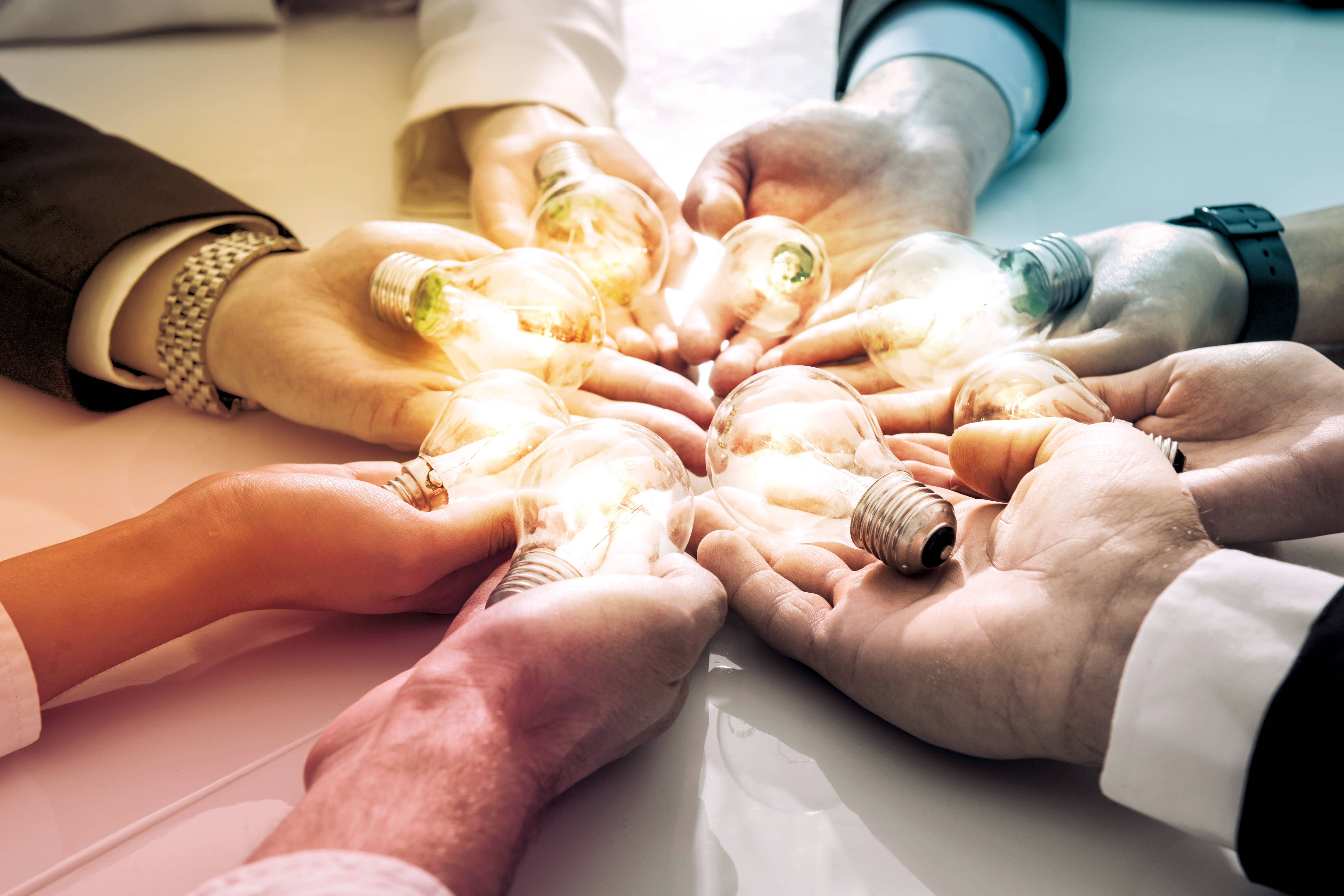 Hände mit Glühbirnen