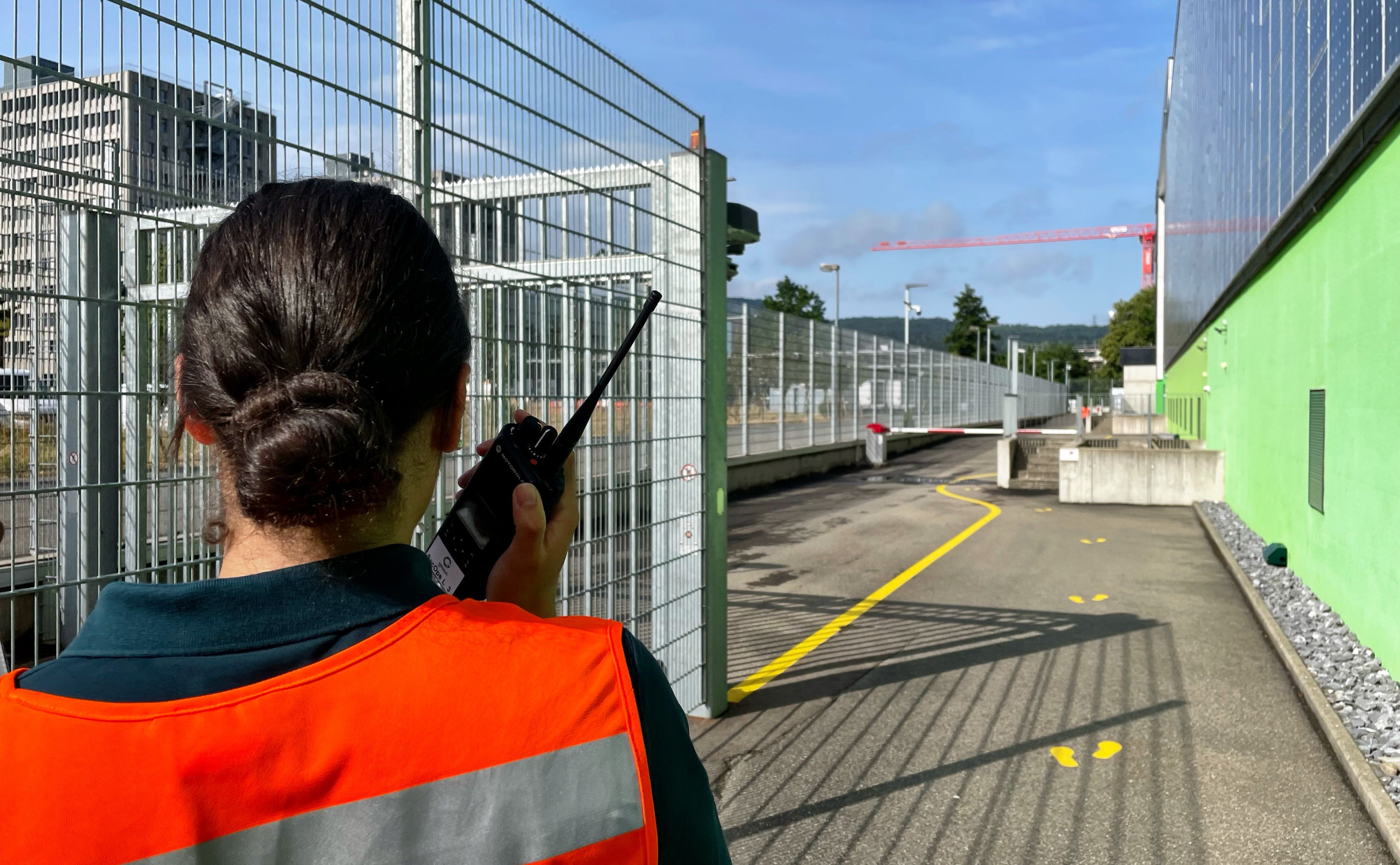 Sicherheitsfrau mit Funkgerät vor Green Datacenter